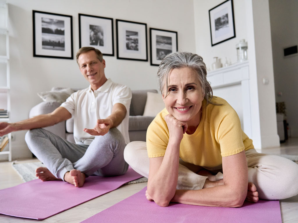 AdobeStock_406508737_1024x768px Mann und Frau auf der Fitnessmatte im Wohnzimmer